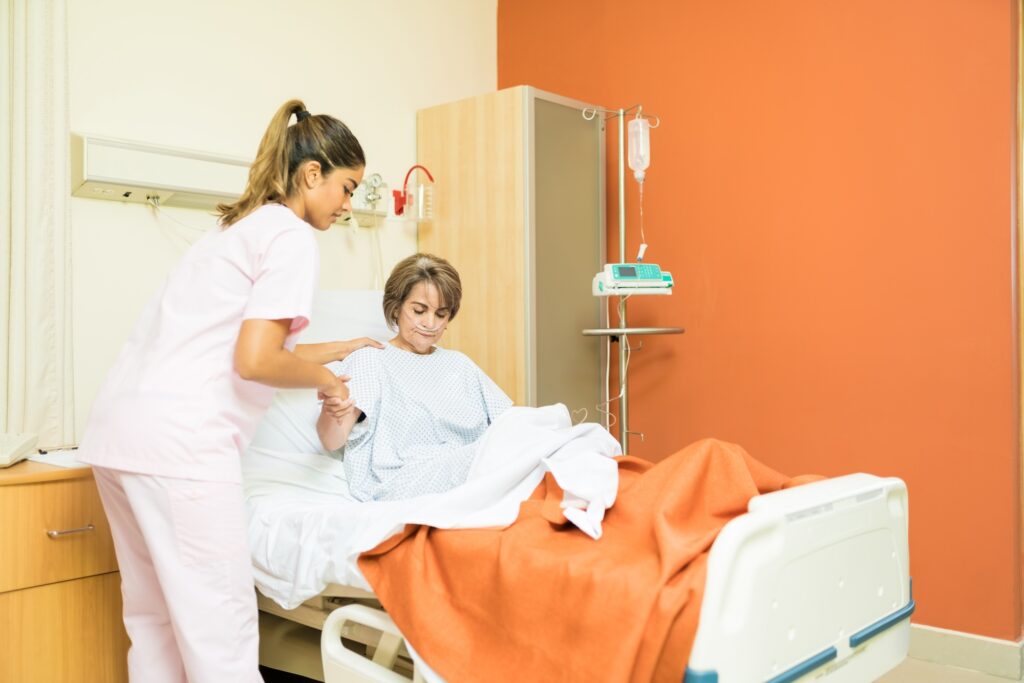 Healthcare Worker Giving Support To Patient In Hospital
